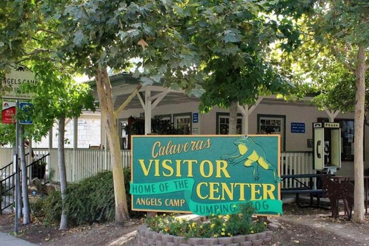 a sign in front of a visitor house of the center