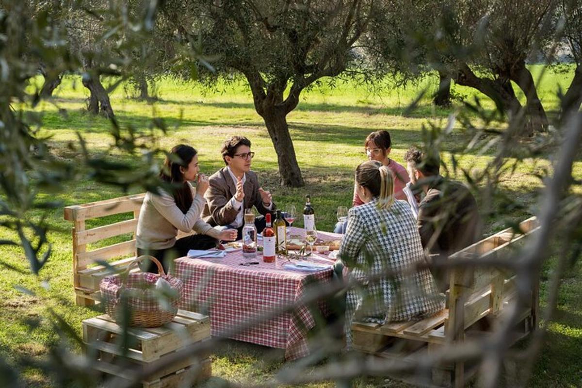 a group of people sitting around a picnic table