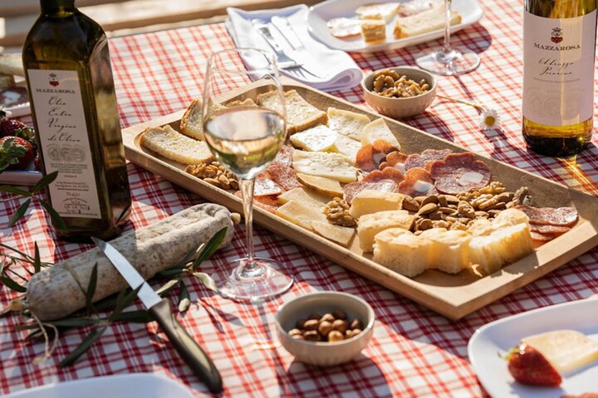 a table with a plate of food and a glass of wine