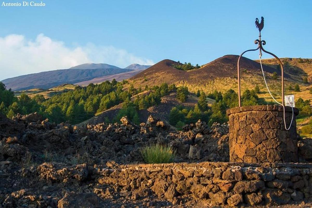 a stone wall with mountains in the background