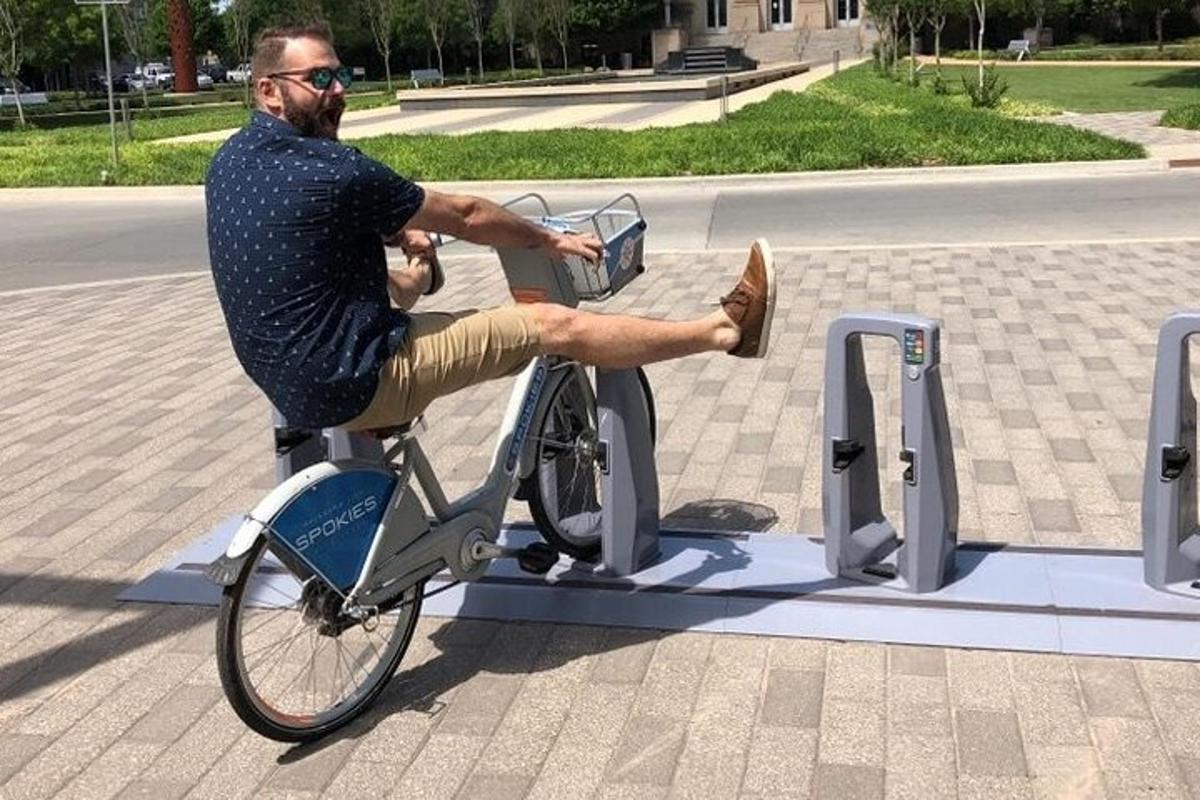 a man riding a bike in a bike stand