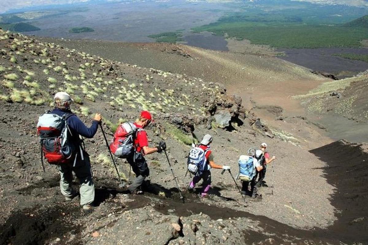 a group of people walking up the side of a mountain