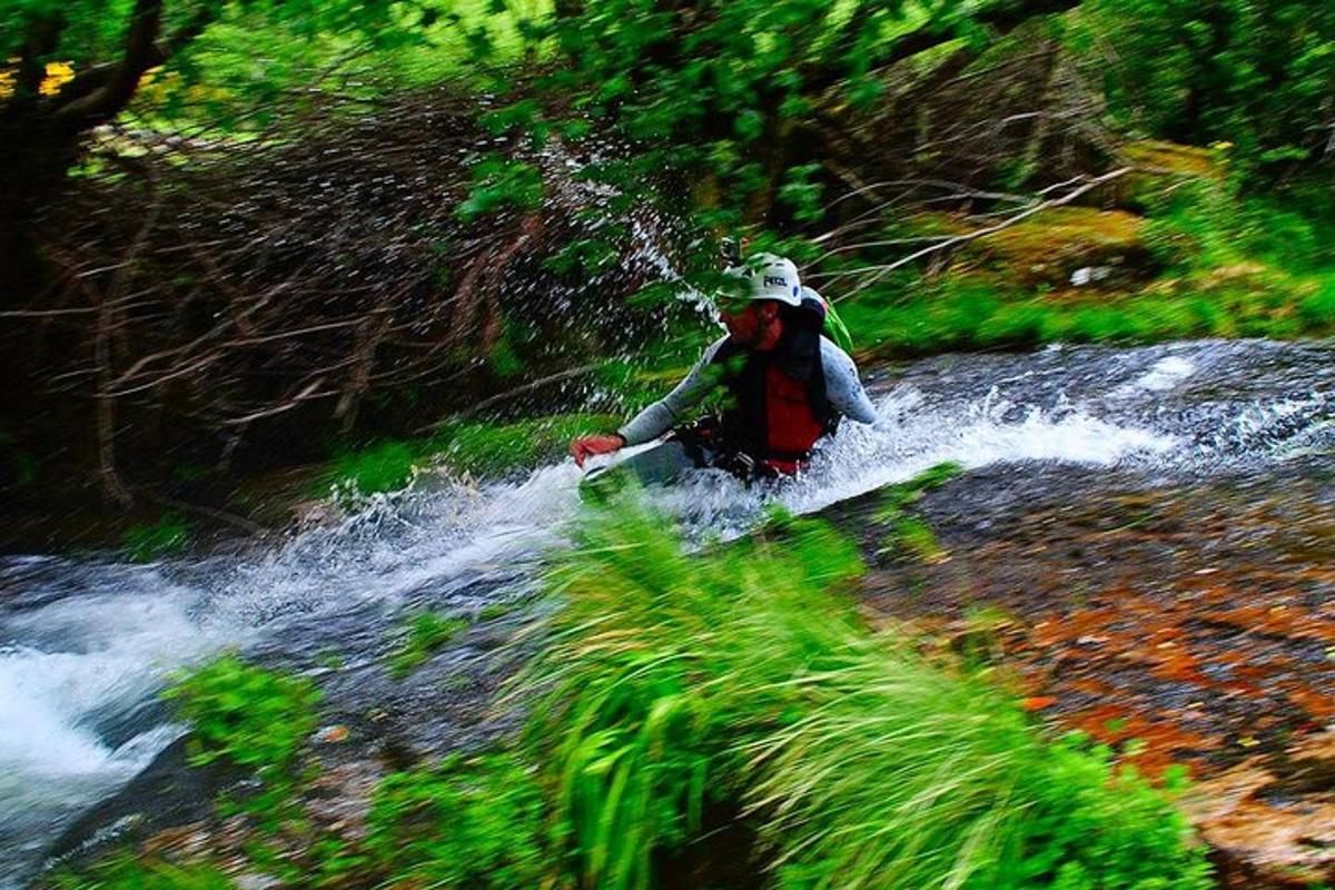 a person is crossing a river with a surfboard