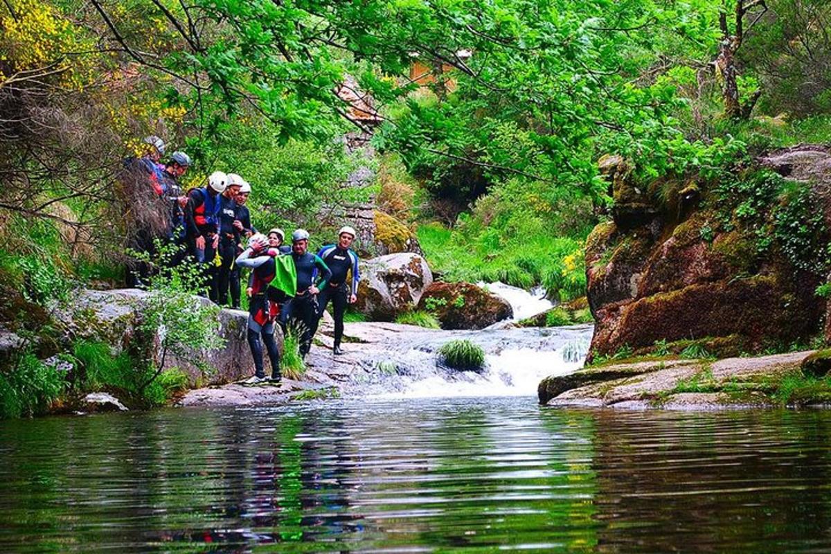 a group of people walking across a river