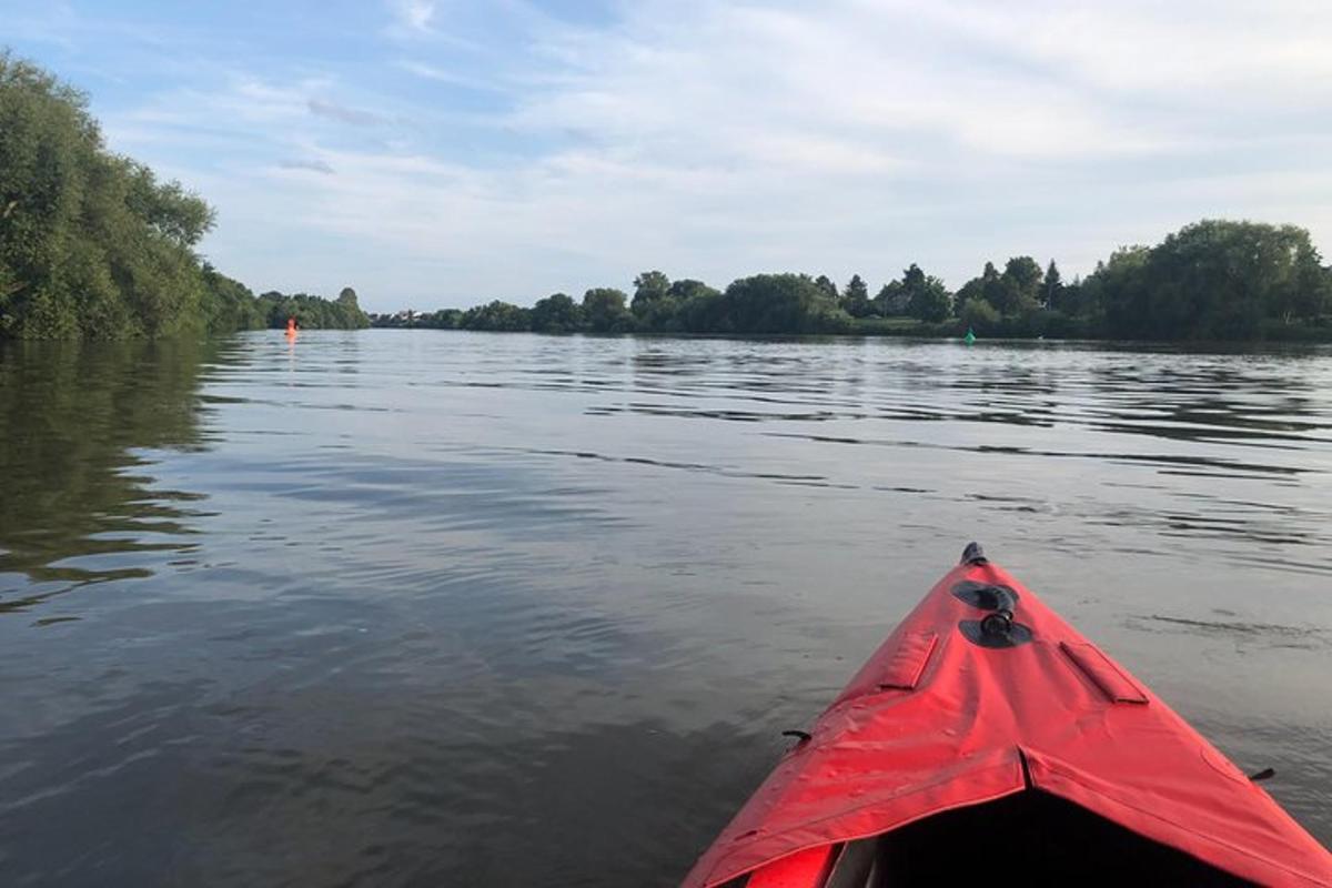 a red kayak in the water on a river