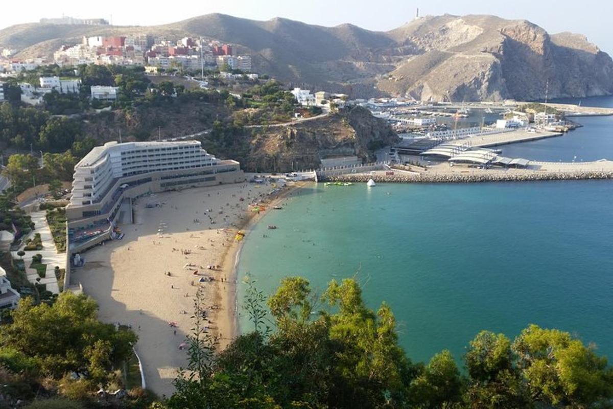 a view of a beach with a resort and the ocean