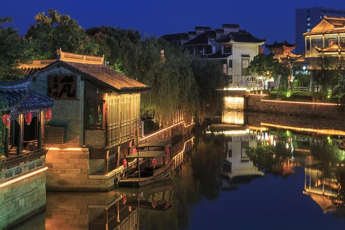 a river with a boat in the water at night