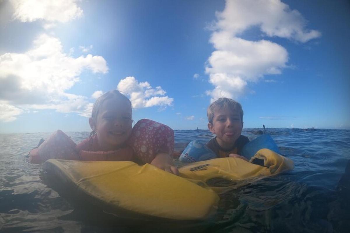 two children riding on a raft in the water