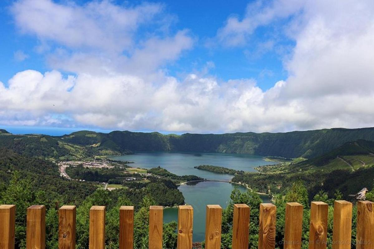 a view of a lake from behind a fence