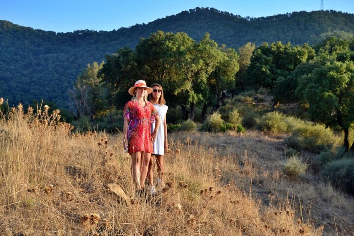 two women walking in a field of tall grass