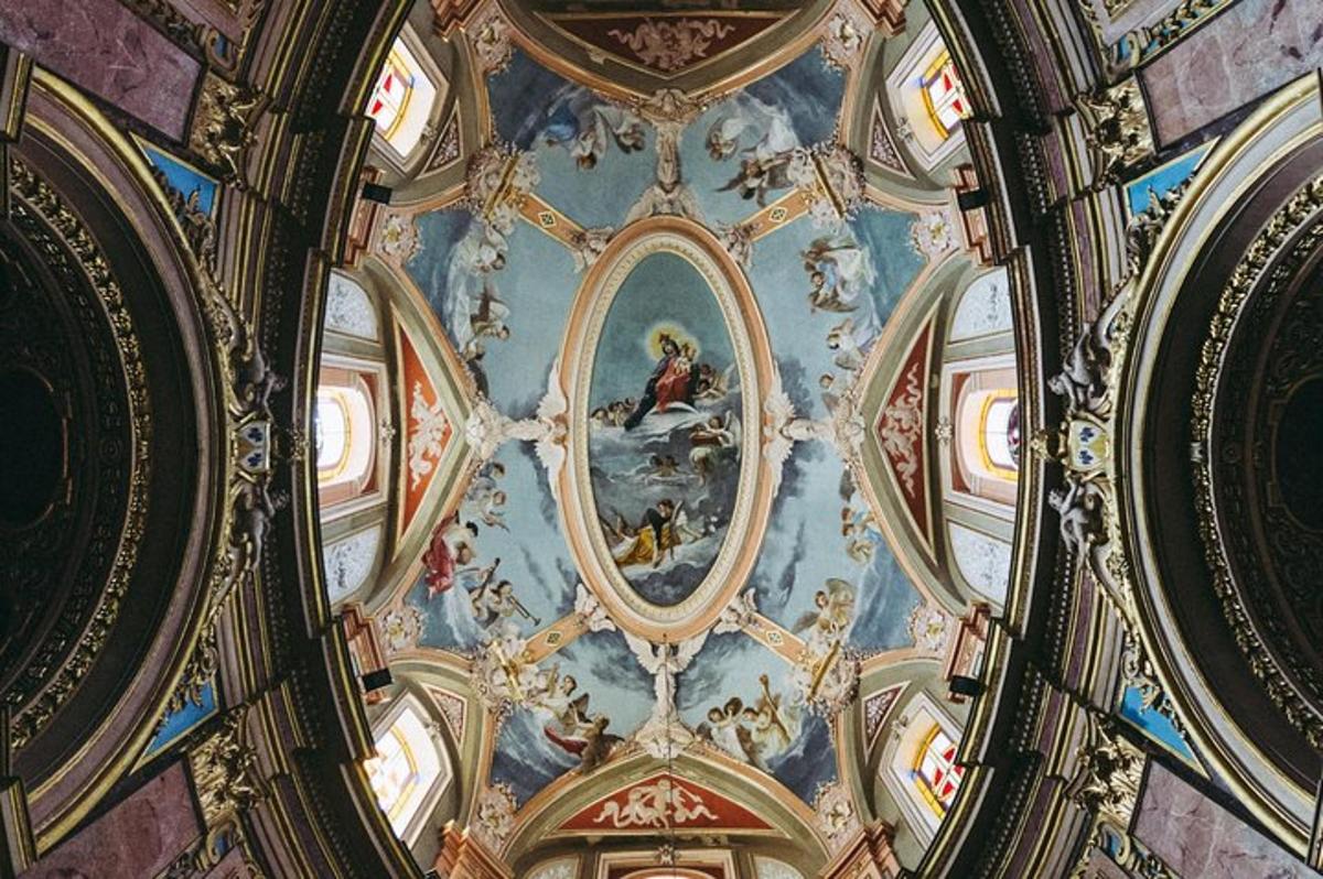 a ceiling of a building with a painting on it