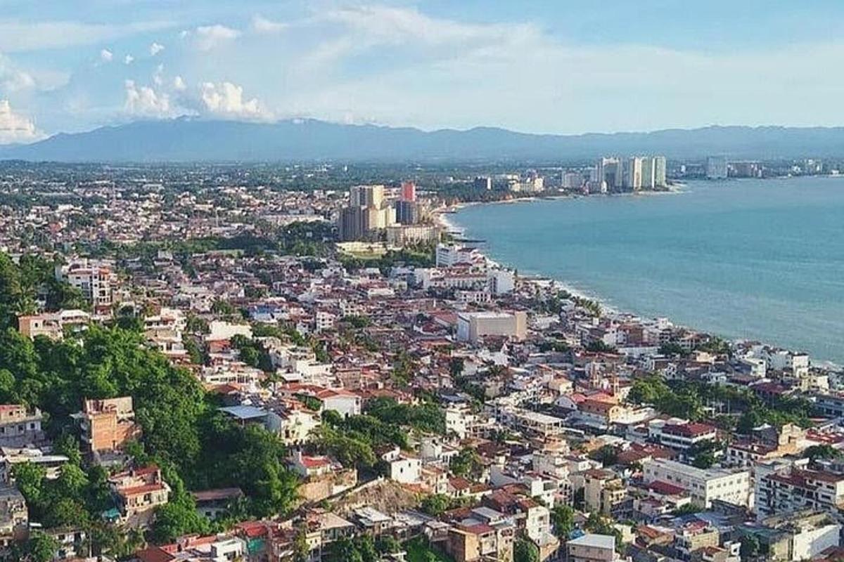 an aerial view of a city next to the water