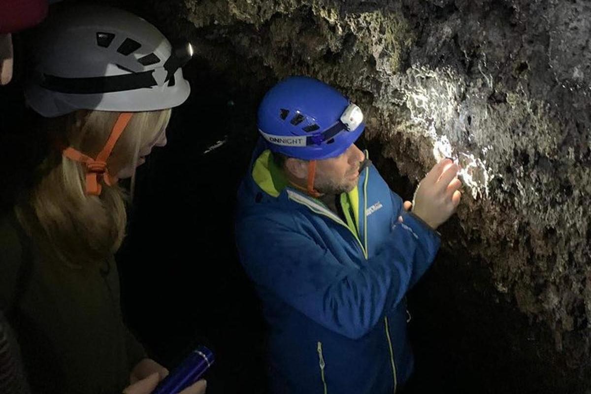 um homem e uma mulher parados em uma caverna