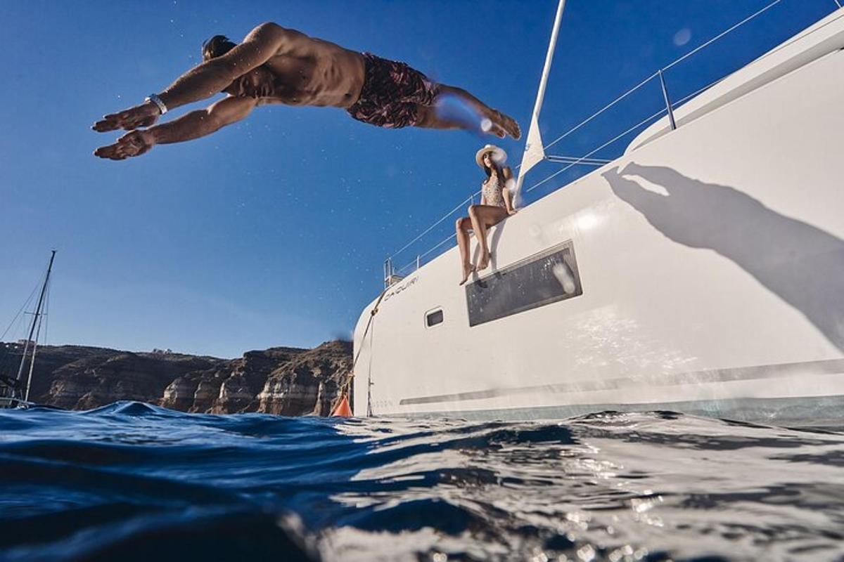 a man standing on the side of a boat in the water