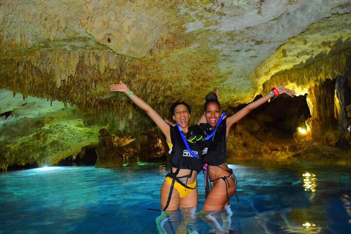 two girls in the water in a cave