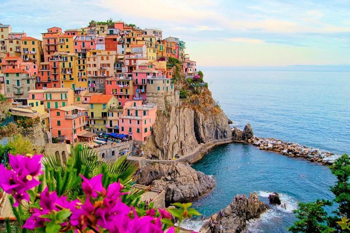 a group of colorful houses on a hill next to the ocean