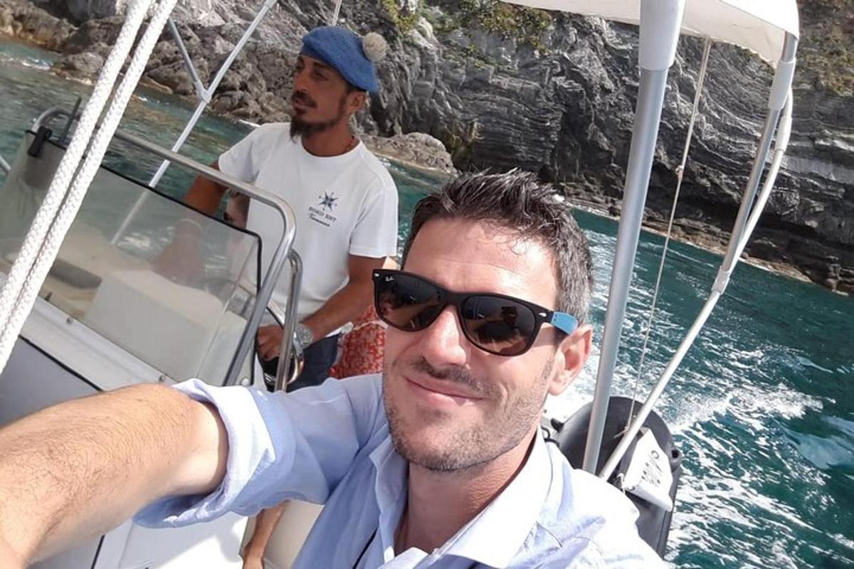 a man in sunglasses on a boat in the water