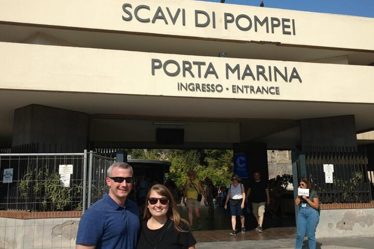 a man and a woman standing in front of a building
