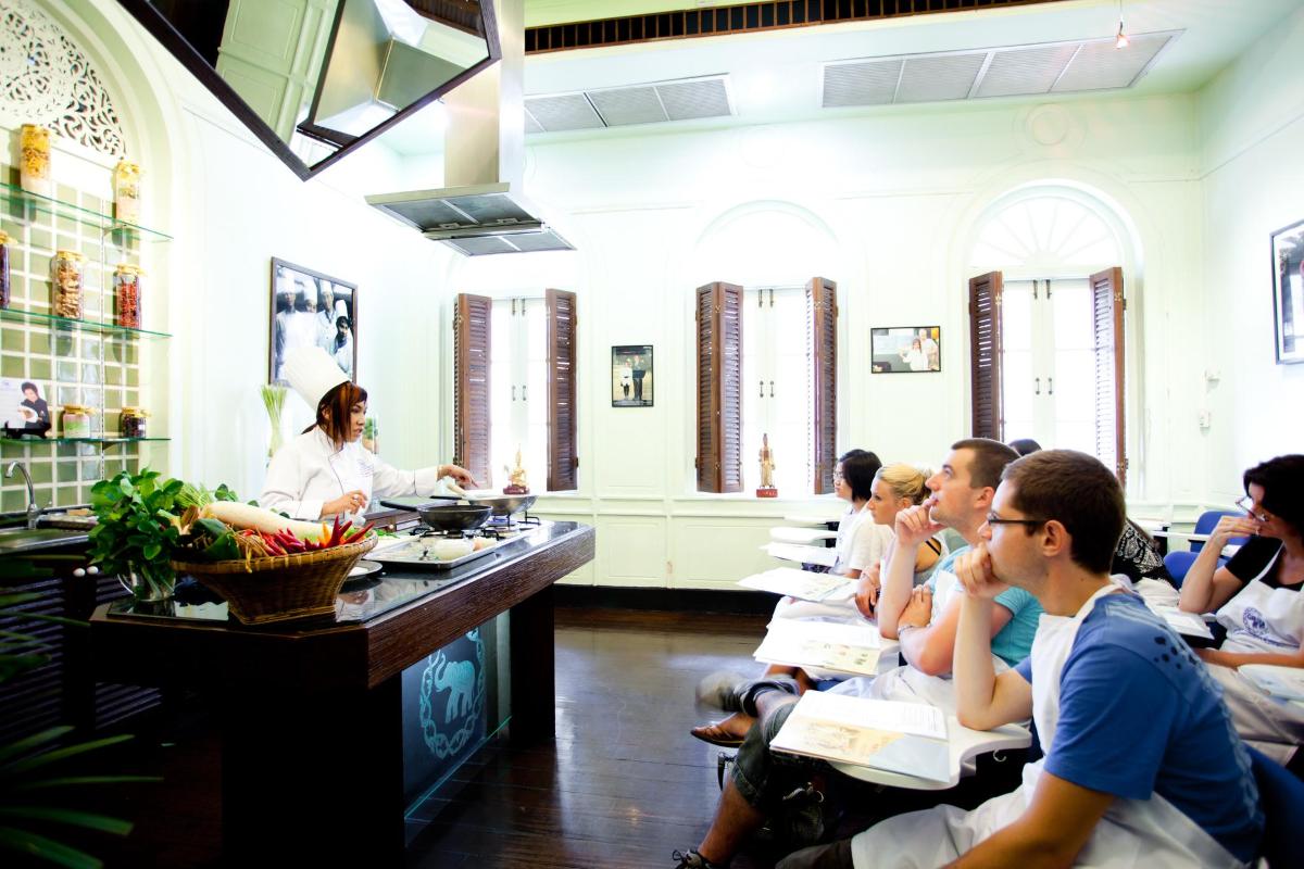 a group of people sitting in a restaurant eating food