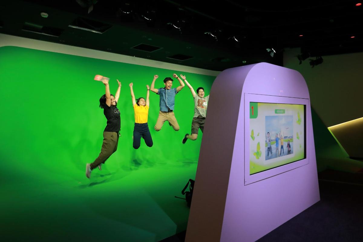 a group of people jumping in a green room