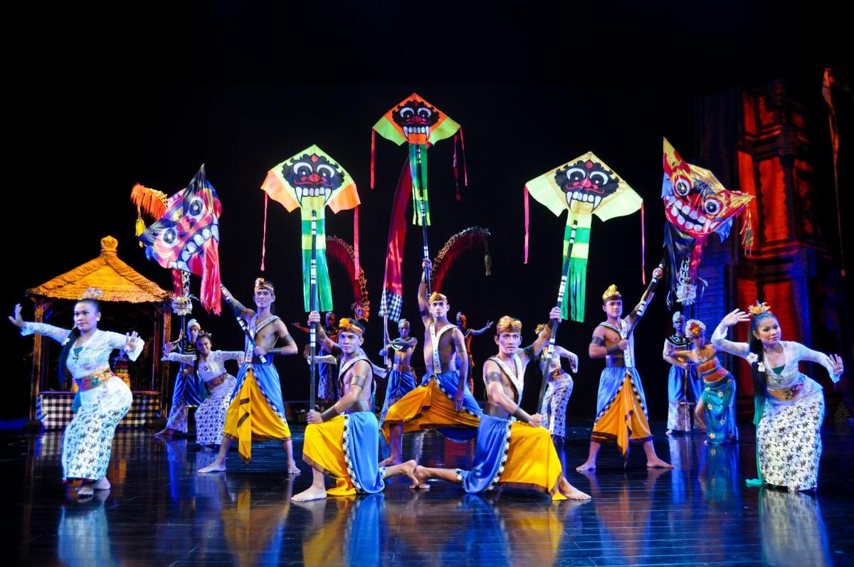 a group of performers in a performance with kites
