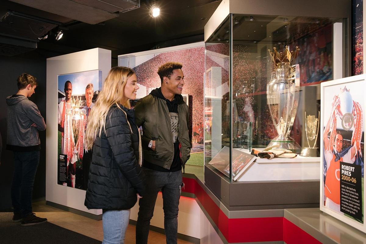 a man and woman looking at a display in a museum