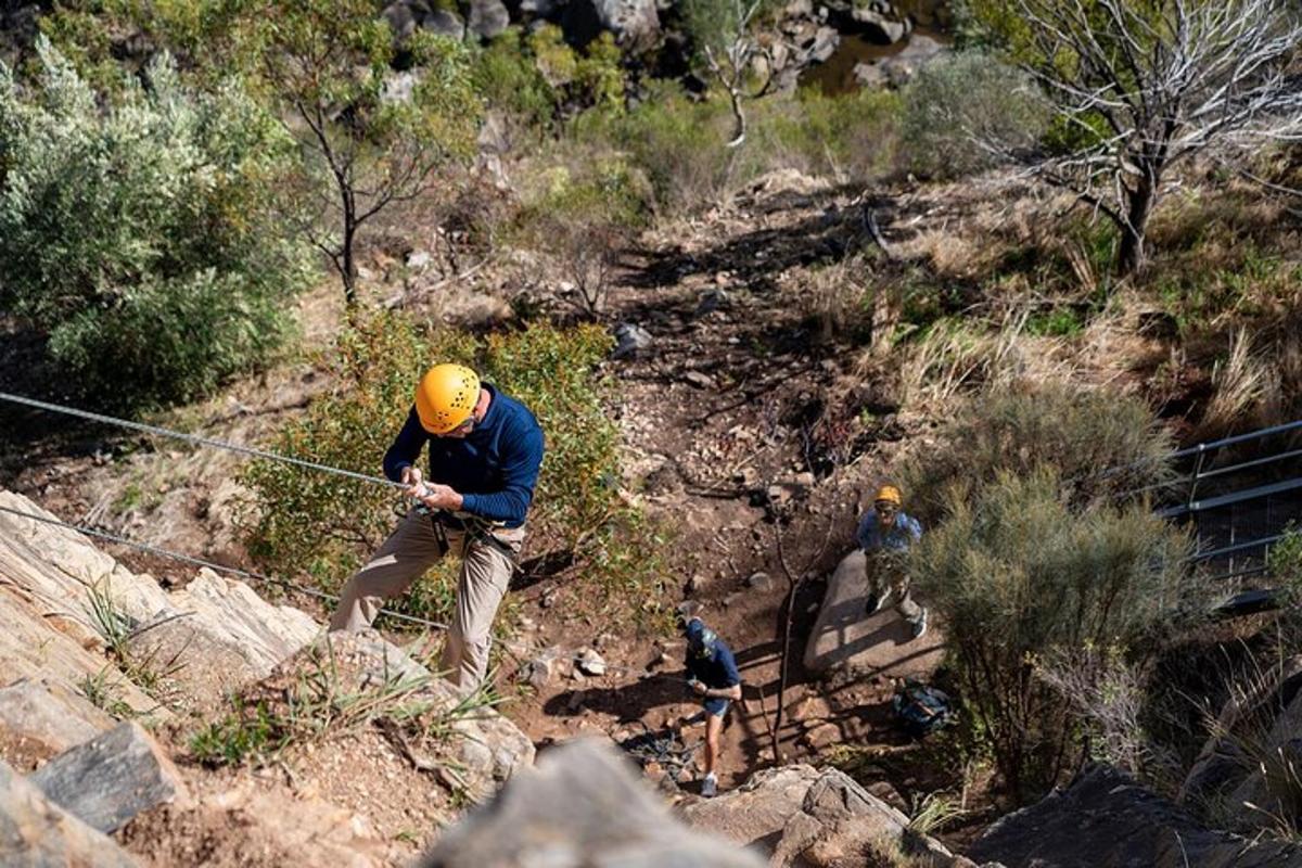 un uomo che si tiene a una corda su una montagna
