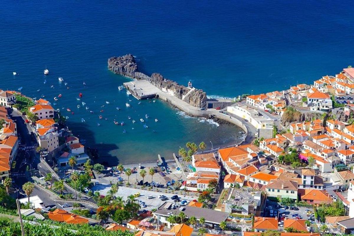 an aerial view of a coastal town with boats in the water