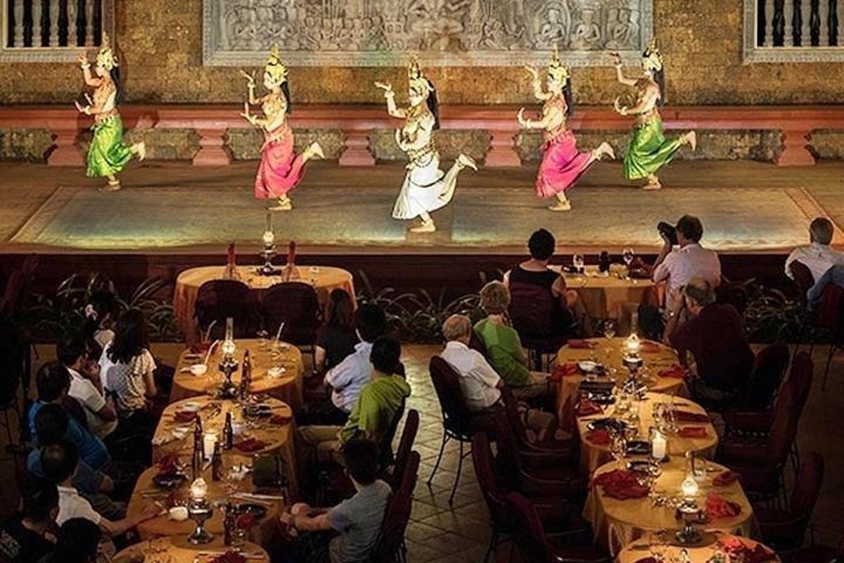 a group of people sitting at tables watching dancers on a stage