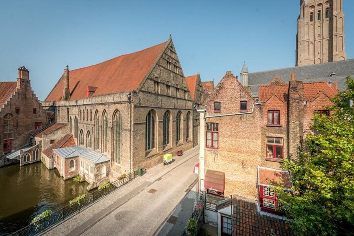 an old building with a clock tower next to a river
