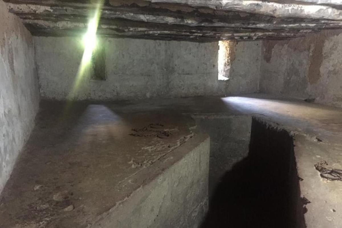 an empty room with a beam of light in a building