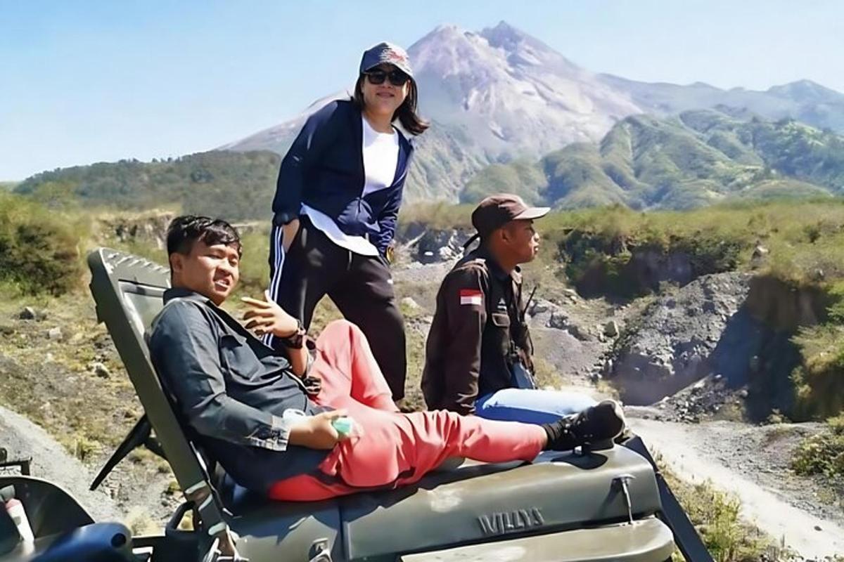 a woman is standing next to two people on a atv