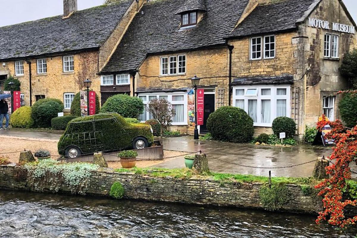 a car parked in front of a building next to a river