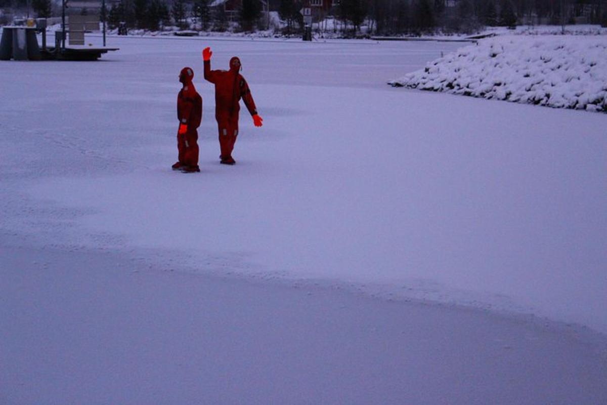 two people standing on a frozen lake in the snow
