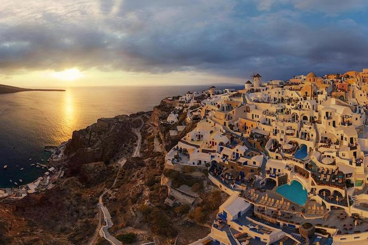 an aerial view of a town on a hill near the ocean