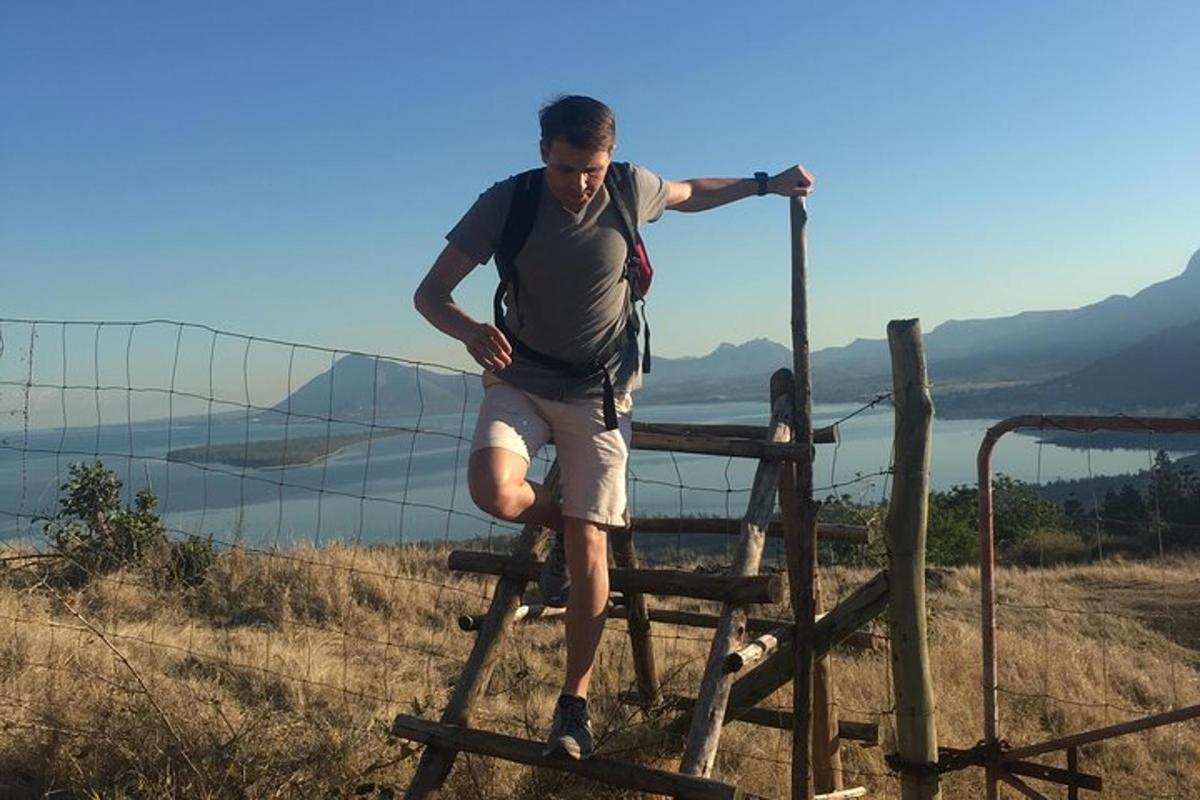 a man is standing on a wooden fence