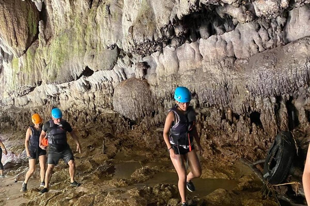 a group of people walking through a cave