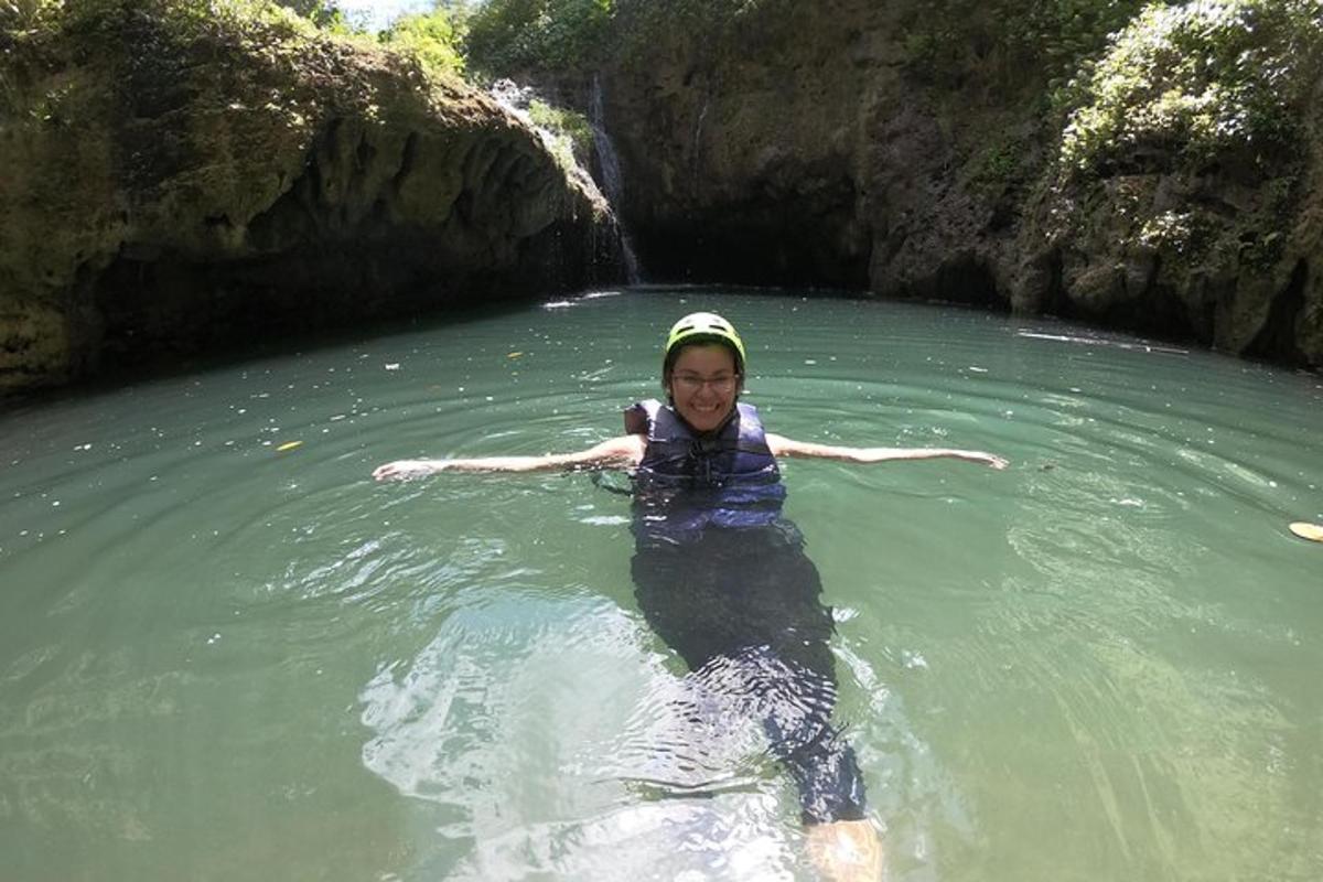 a young girl is swimming in a river