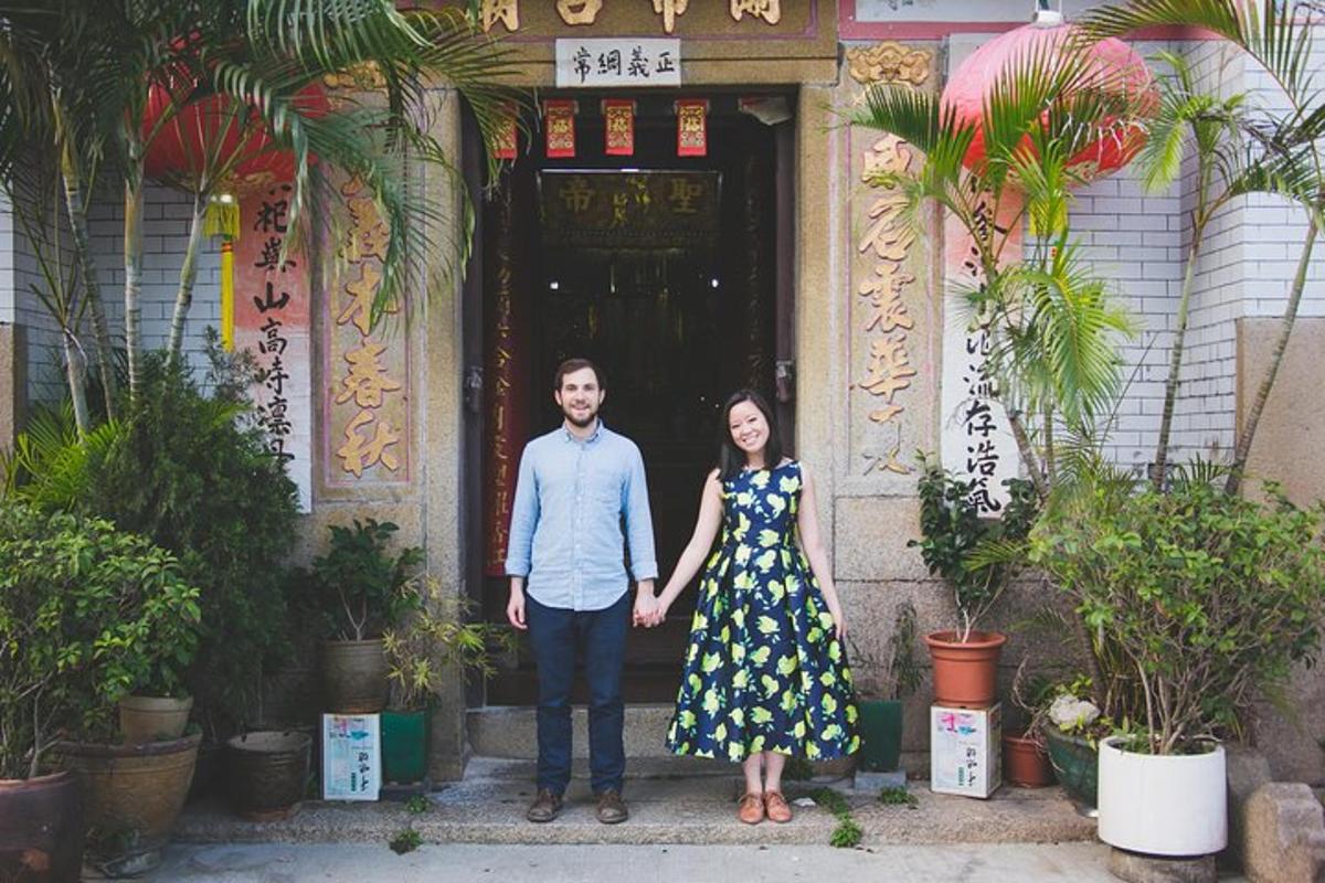 a man and a woman standing in front of a building