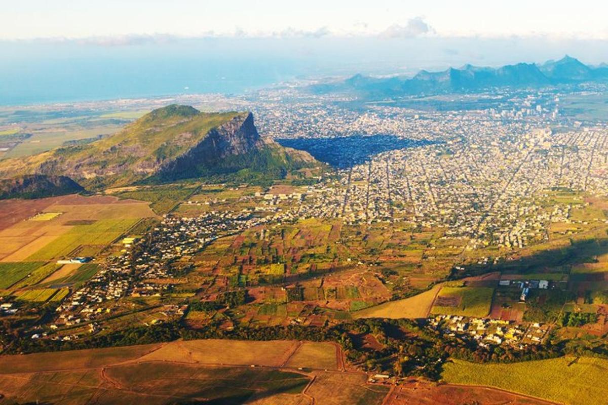 an aerial view of a city with a mountain