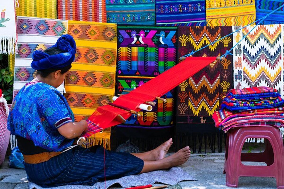 a woman is working on a display of colorful fabrics