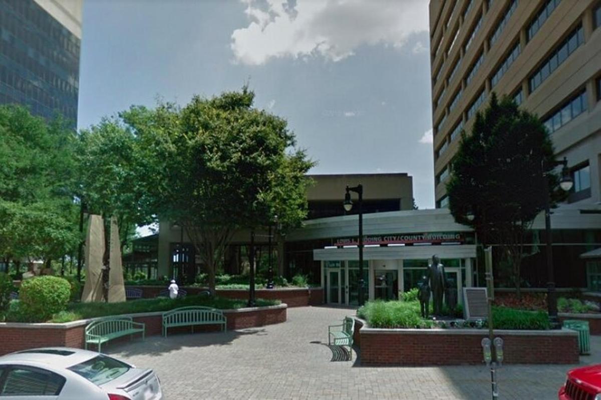 a parking lot with benches in front of a building