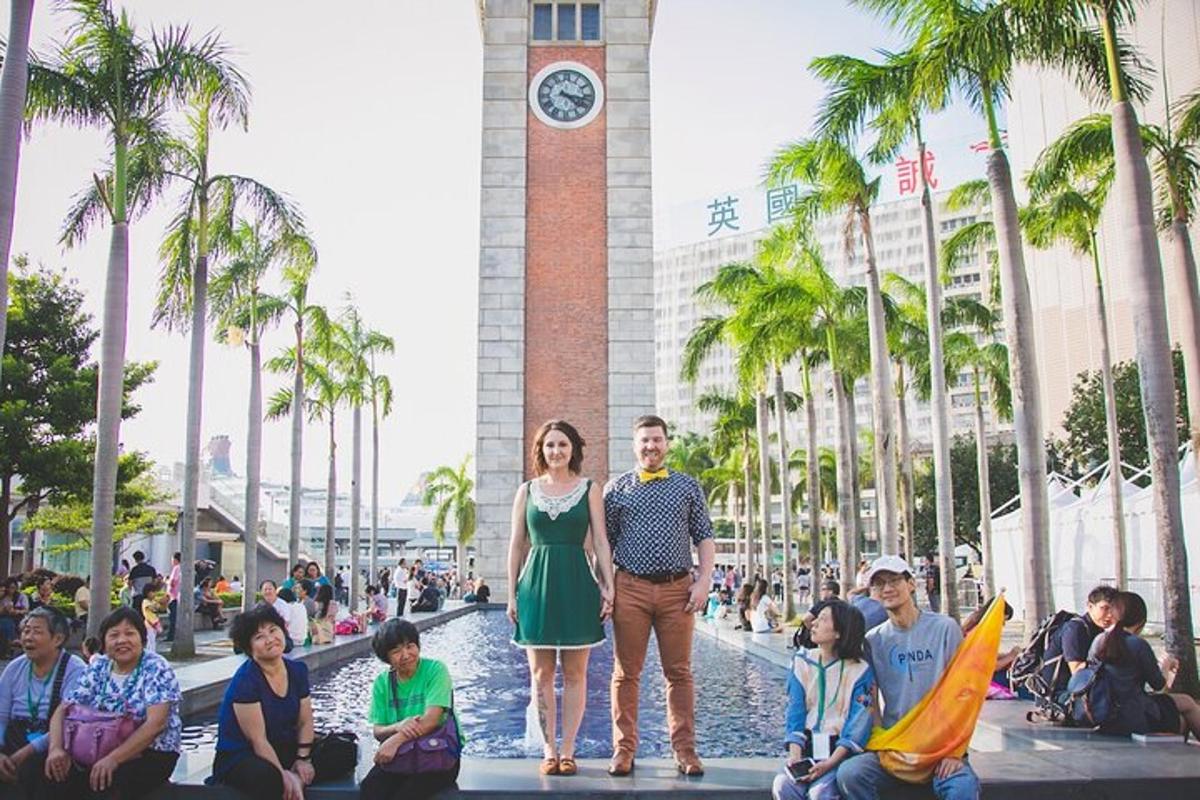 a man and woman standing in front of a clock tower