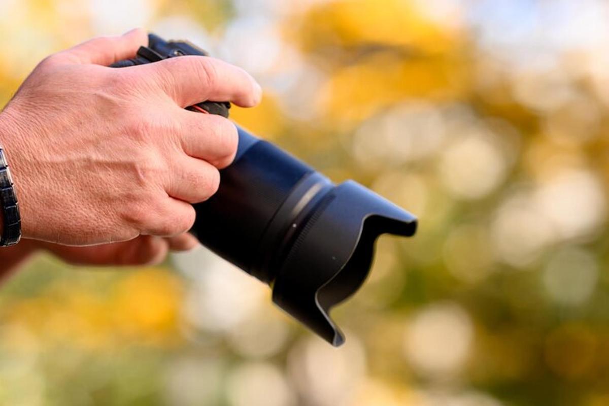 a person holding a black firearm in their hand