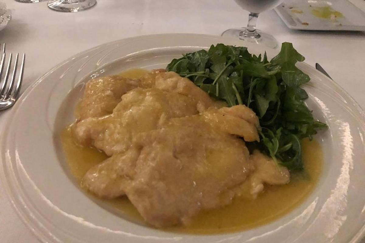 a plate of food with meat and greens on a table
