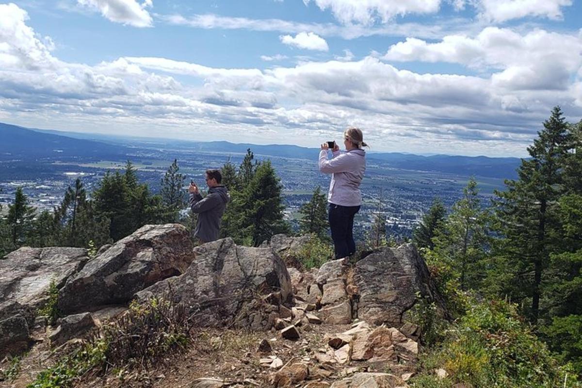 a couple of people standing on top of a mountain