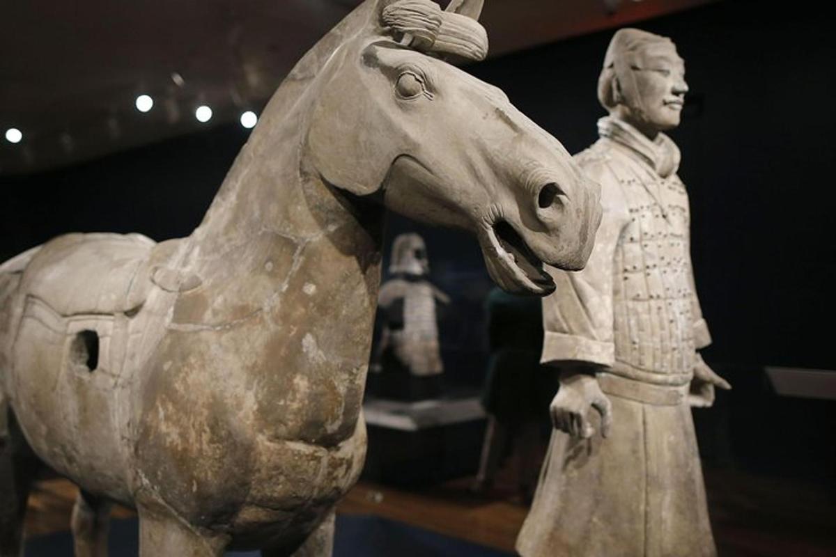 a statue of a man standing next to a horse