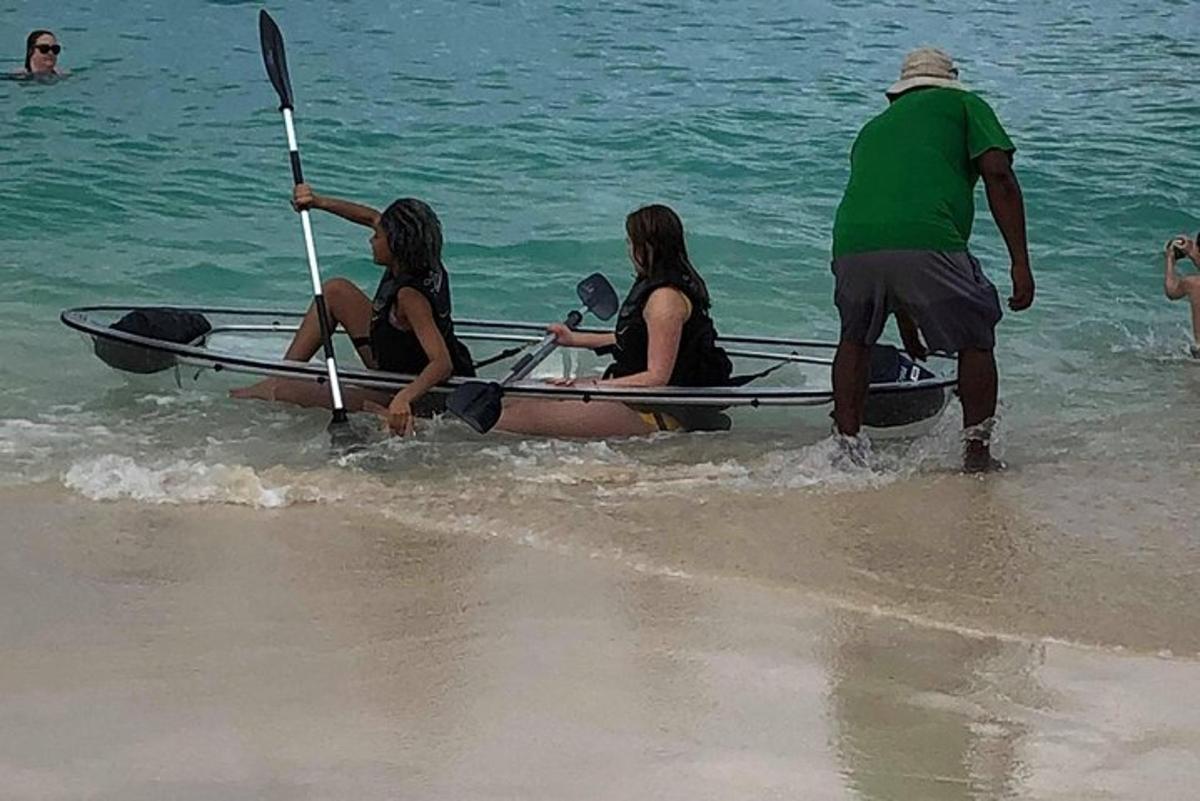a group of people in a boat on the beach