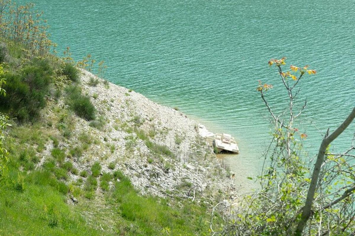a boat sitting on the shore of a body of water