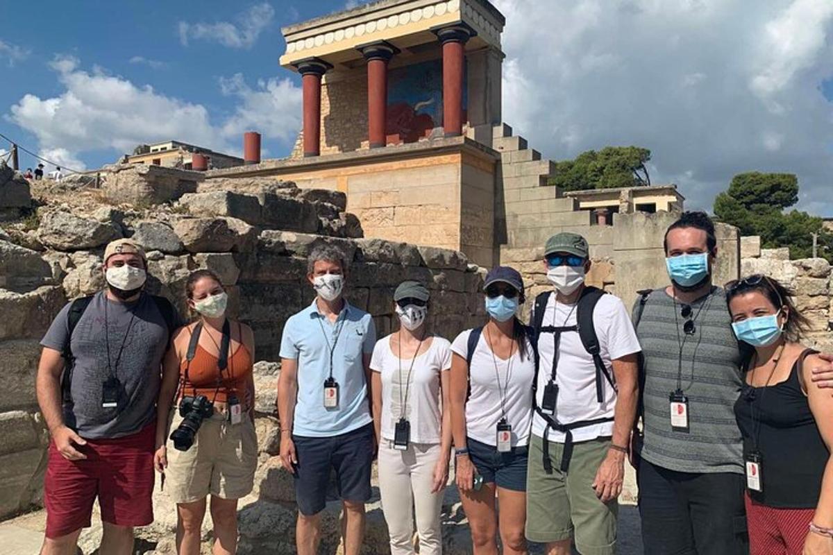 um grupo de pessoas usando máscaras em pé em frente a um templo
